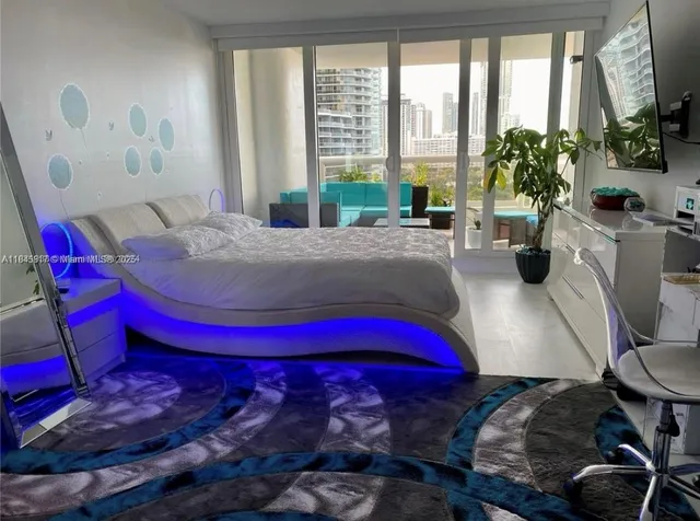 a bedroom with a bed and a potted plant