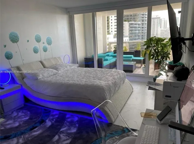 a bedroom with a bed and a potted plant