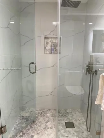a bathroom with a toilet and a shower