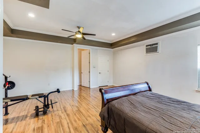 a bedroom with a bed and a chandelier