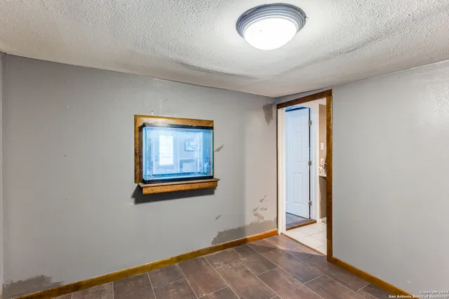 an empty room with windows and closet