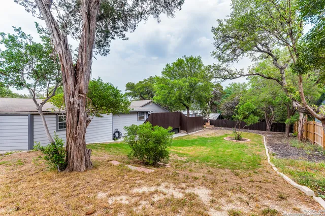 a backyard of a house with yard and outdoor seating