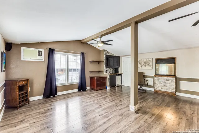 a open kitchen with granite countertop a stove and a refrigerator