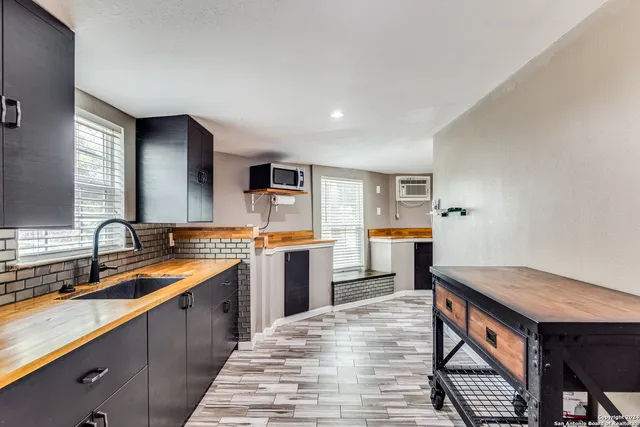 a kitchen with sink cabinets and wooden floor