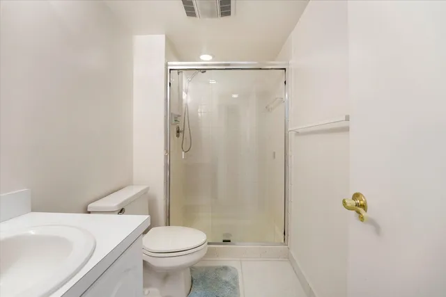 a white toilet sitting next to a bathroom sink