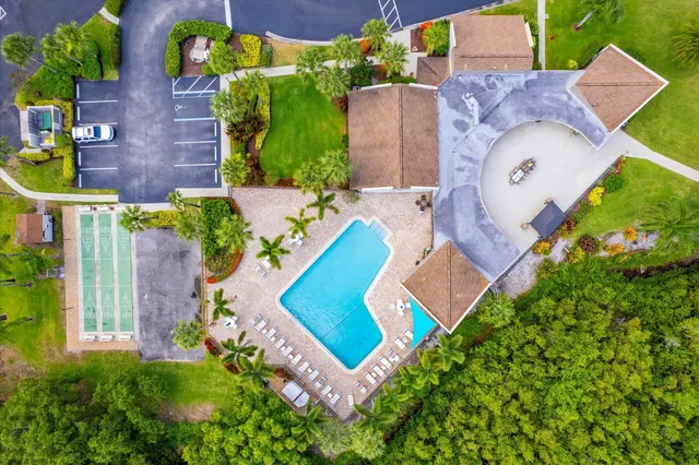 an aerial view of a house with a yard and plants