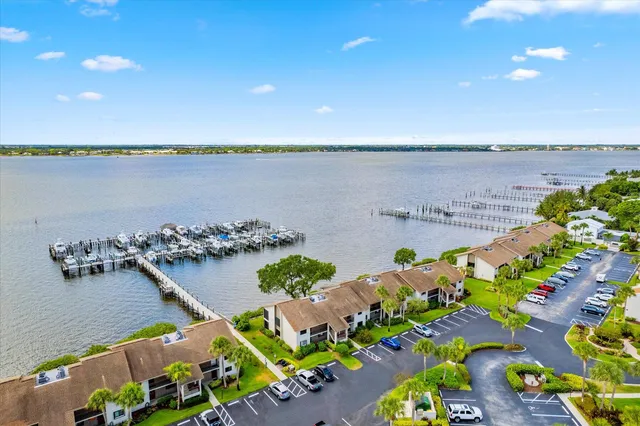 an aerial view of a house with a garden and lake view