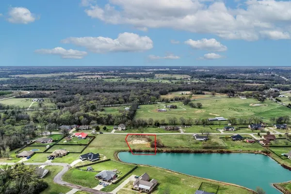 an aerial view of a city with a lake view