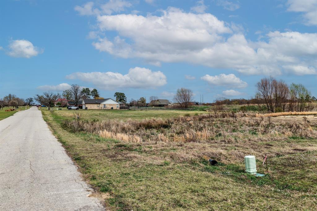 119 Dolly Road Sulphur Springs, TX 75482 - Photo 4 of 8 a view of a lake with a building in the background