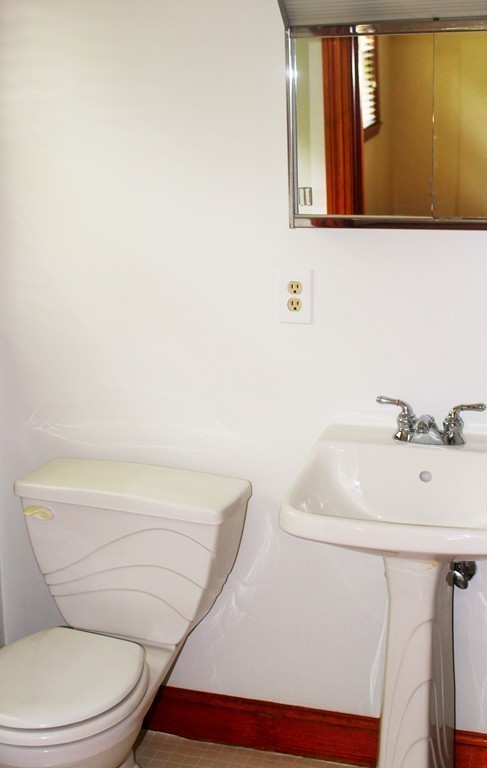 15 Alpine Road Norwood, MA 02062 - Photo 17 of 18 a bathroom with a toilet a sink and mirror