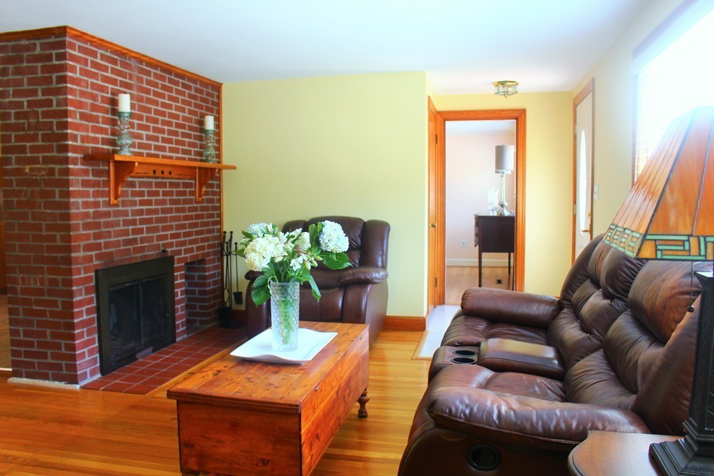 15 Alpine Road Norwood, MA 02062 - Photo 3 of 18 a living room with furniture a fireplace and a potted plant