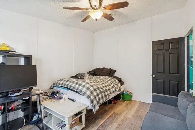 a bedroom with a bed and a computer on a desk