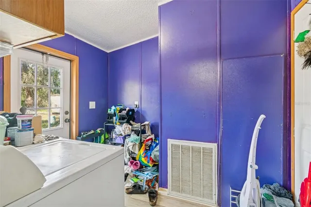 a dining room with furniture and a potted plant