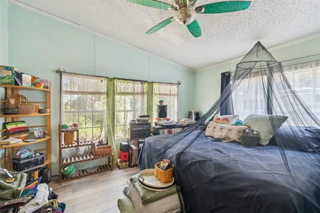 a bedroom with a bed and a chandelier