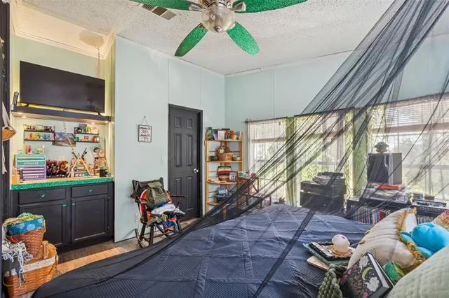 a living room with furniture a flat screen tv and a window