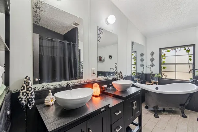 a bathroom with a granite countertop sink and a large mirror