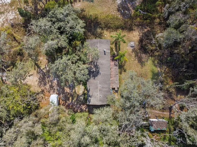 an aerial view of a houses with a yard