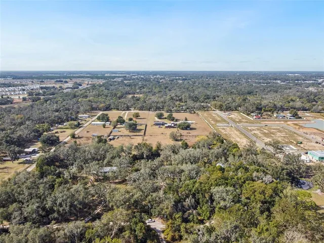 an aerial view of a house with a beach