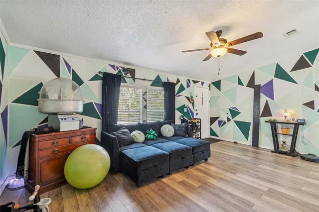 a living room with furniture and wooden floor