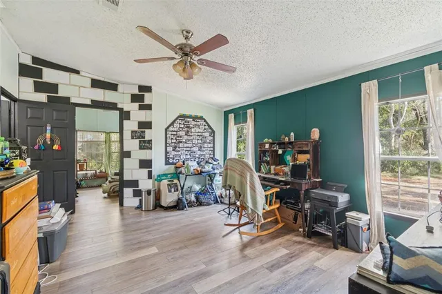 a view of a livingroom with furniture and a window