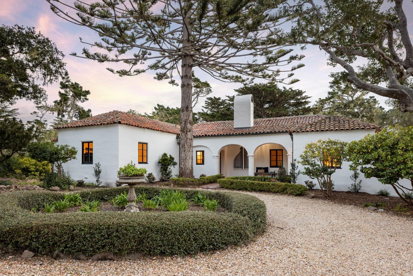 a view of a white house with a big yard and large tree