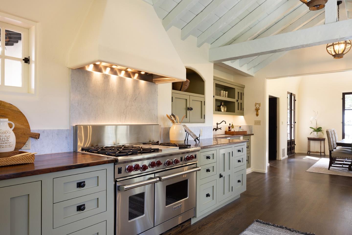 3269 Cabrillo Road Pebble Beach, CA 93953 - Photo 13 of 44 a kitchen with stainless steel appliances granite countertop a stove and a refrigerator