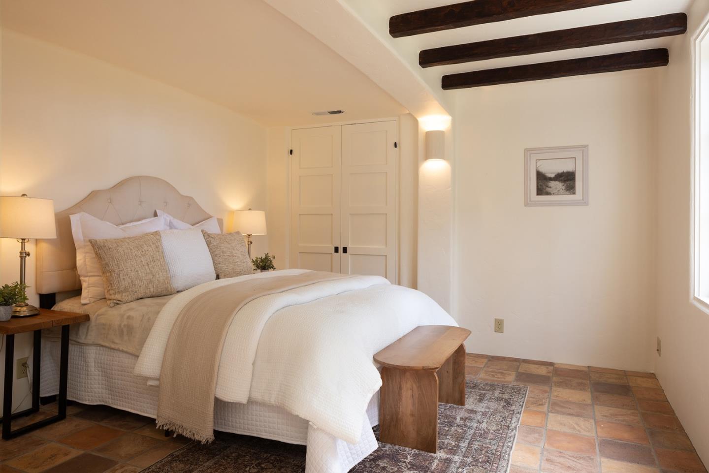 3269 Cabrillo Road Pebble Beach, CA 93953 - Photo 31 of 44 a spacious bedroom with a bed and lamp