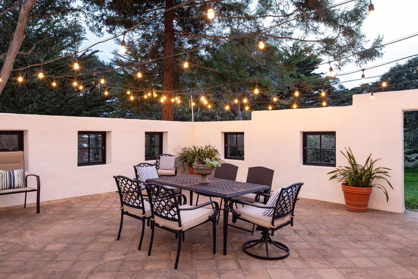 3269 Cabrillo Road Pebble Beach, CA 93953 - Photo 33 of 44 a view of a patio with a table and chairs