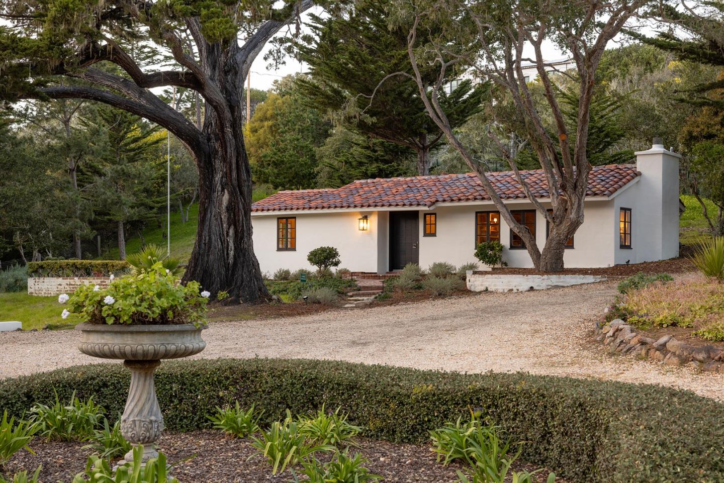 3269 Cabrillo Road Pebble Beach, CA 93953 - Photo 37 of 44 a front view of a house with a garden and plants