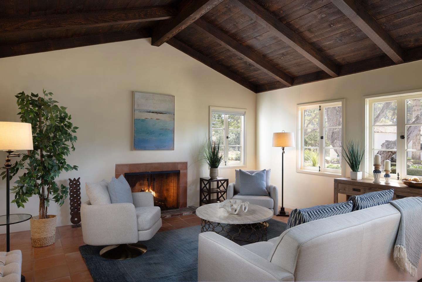 3269 Cabrillo Road Pebble Beach, CA 93953 - Photo 38 of 44 a living room with furniture a fireplace and a potted plant