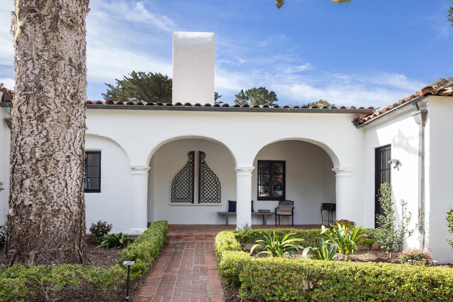 3269 Cabrillo Road Pebble Beach, CA 93953 - Photo 5 of 44 a front view of a house with a garden
