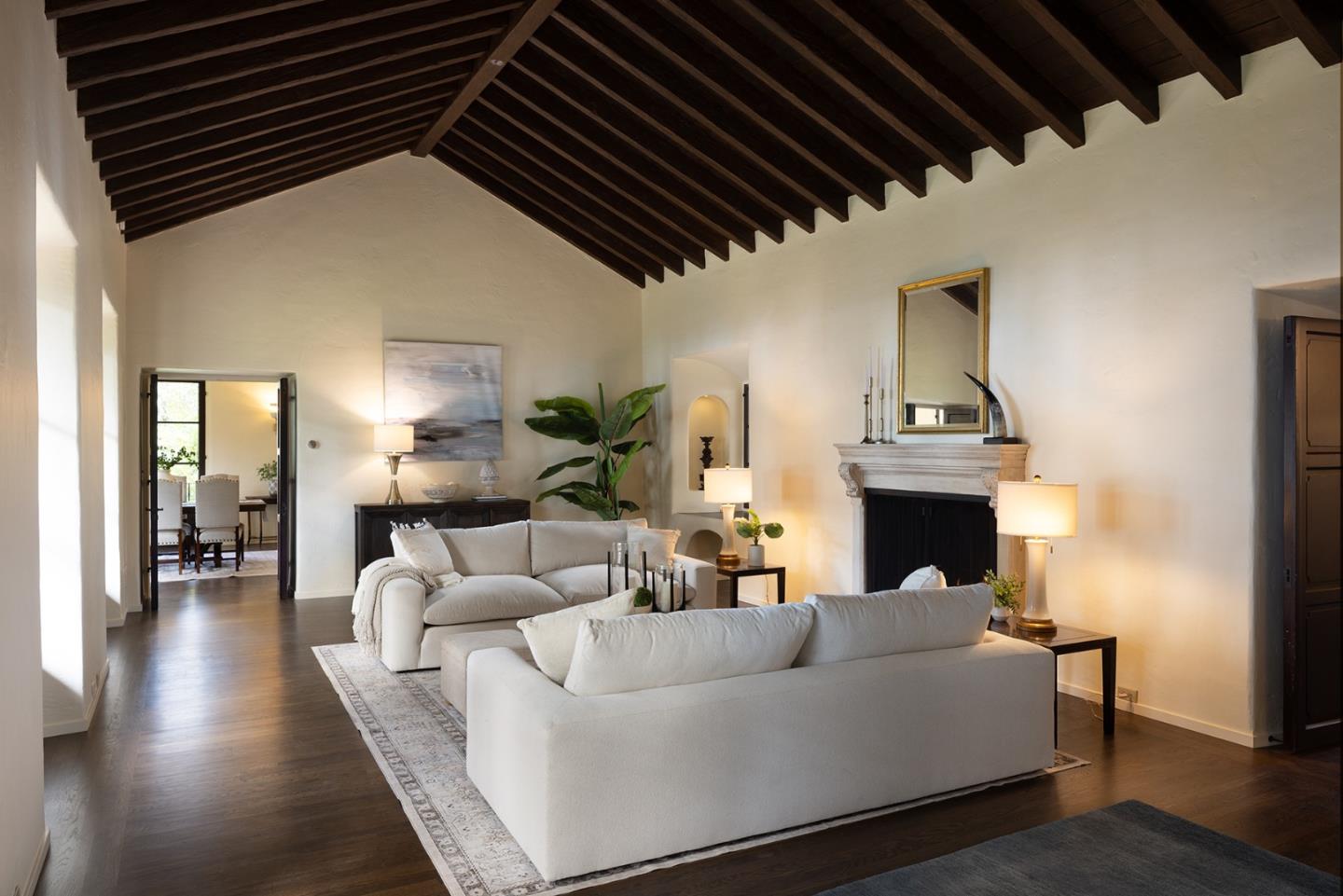 3269 Cabrillo Road Pebble Beach, CA 93953 - Photo 10 of 44 a living room with furniture a fireplace and a chandelier