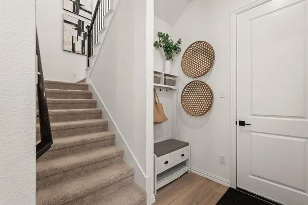 a view of entryway and hall with wooden floor
