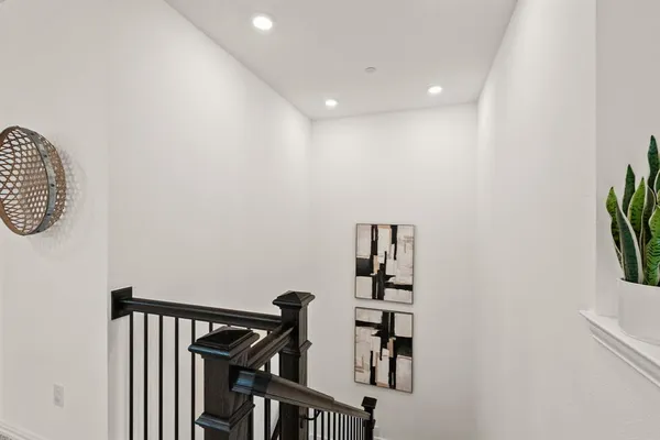 a view of a hallway with paintings on the wall