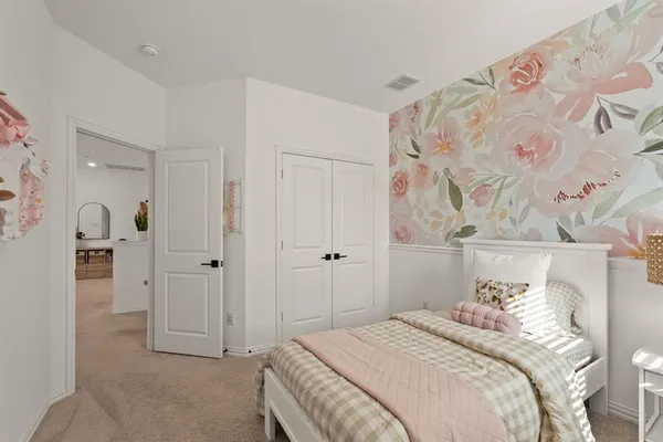 a bedroom with a bed and a painting on the wall