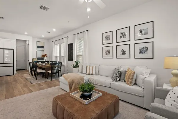 a living room with furniture and painting on the wall
