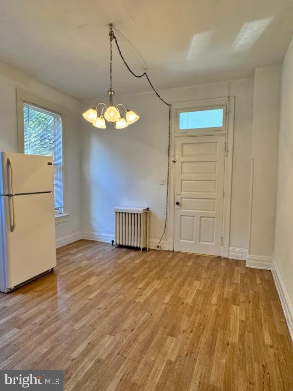 140 East Philadelphia Street, Unit 4 York, PA 17401 - Photo 2 of 5 a view of a room with wooden floor and a refrigerator