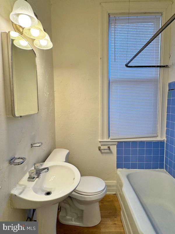 140 East Philadelphia Street, Unit 4 York, PA 17401 - Photo 5 of 5 a bathroom with a sink a toilet and mirror