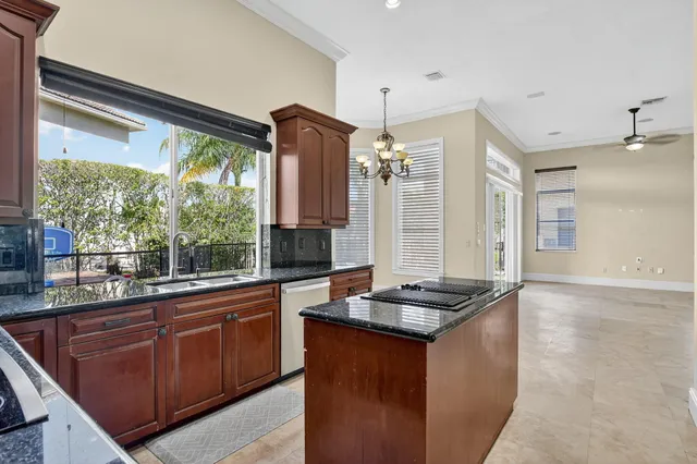 a kitchen with granite countertop a sink and a stove