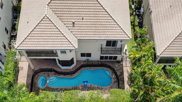 an aerial view of a house with garden and plants