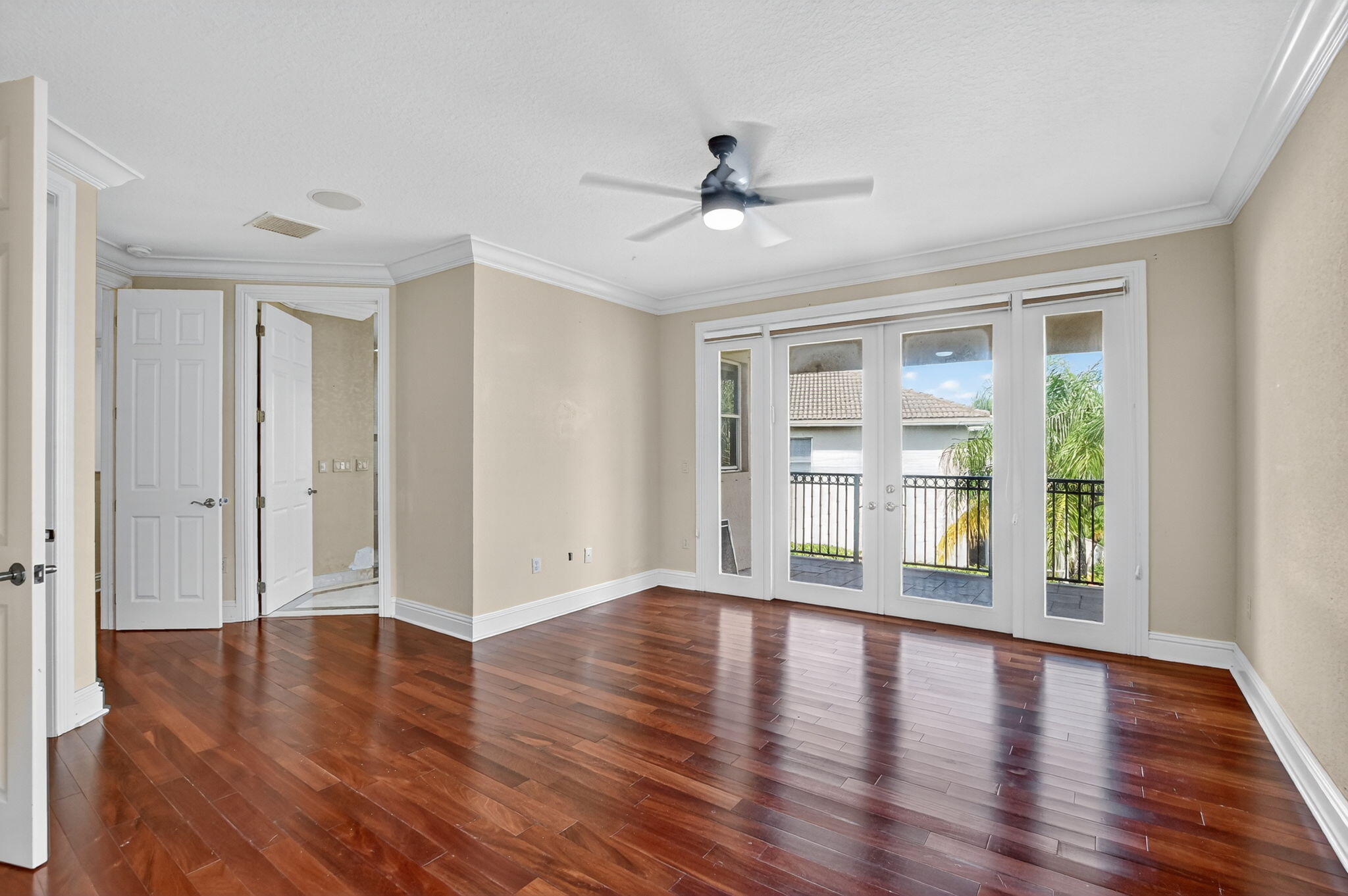 9833 Palma Vista Way Boca Raton, FL 33428 - Photo 28 of 45 a view of an empty room with wooden floor and a window