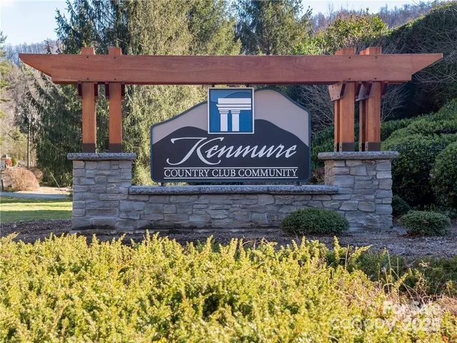 a view of sign board with flower garden