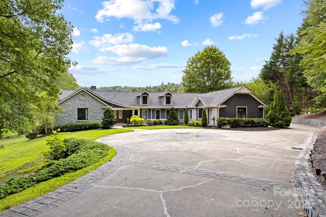 a house with green field in front of it