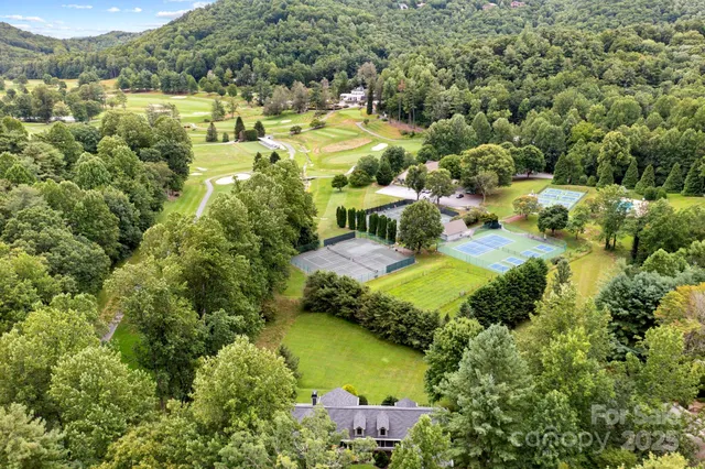 an aerial view of residential houses with outdoor space and swimming pool