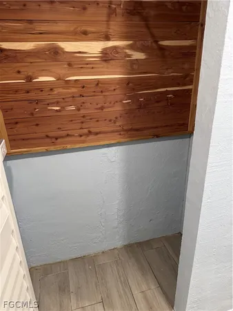 a picture of a bench in front of a wall