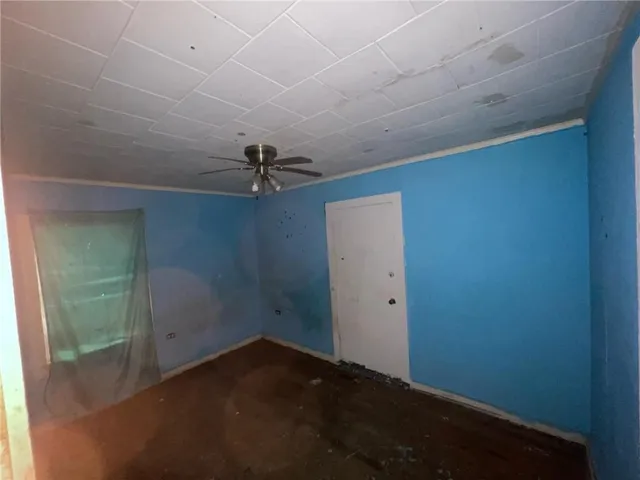 a view of a room with a ceiling fan