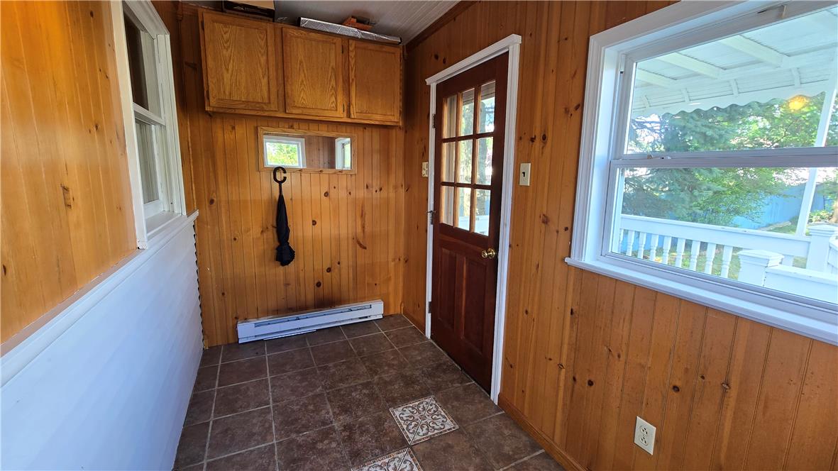 883 North Locust Street Hazleton, PA 18201 - Photo 22 of 83 A charming wood-paneled entryway welcomes guests, offering a glimpse of the outdoors through sunlit windows.