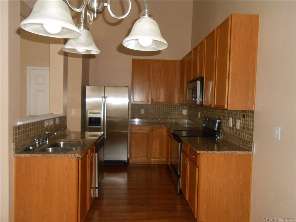11605 Downy Birch Road Charlotte, NC 28227 - Photo 11 of 21 a kitchen with stainless steel appliances granite countertop a sink a stove and a refrigerator