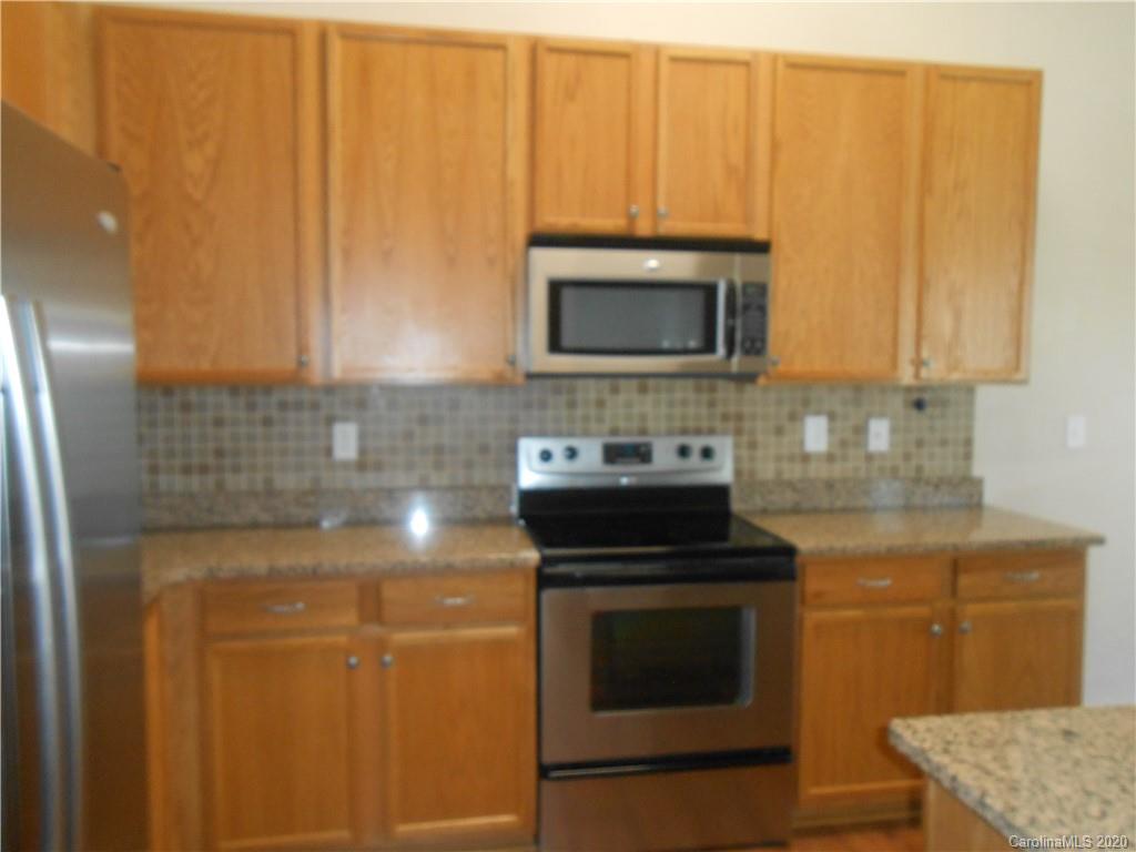 11605 Downy Birch Road Charlotte, NC 28227 - Photo 12 of 21 a kitchen with granite countertop cabinets stainless steel appliances and a counter space