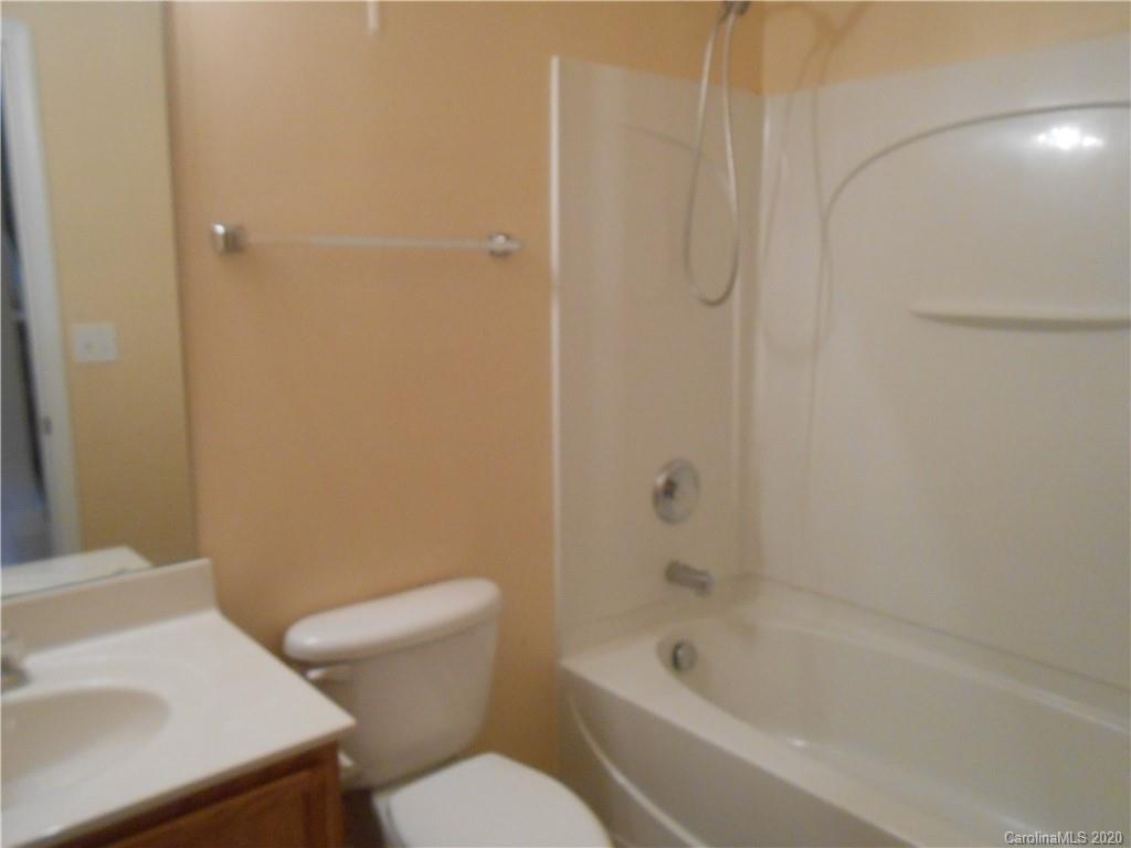 11605 Downy Birch Road Charlotte, NC 28227 - Photo 14 of 21 a white toilet sitting next to a bath tub